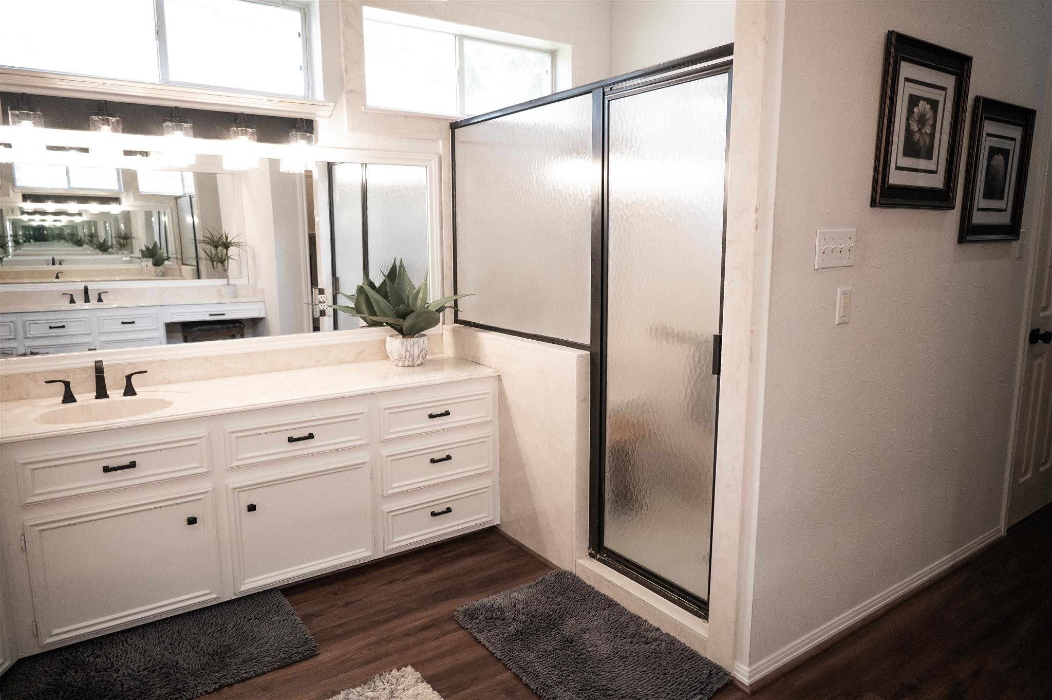 77 Panorama Drive Conroe, TX 77304 - Photo 30 of 49 a bathroom with a double vanity sink and mirror