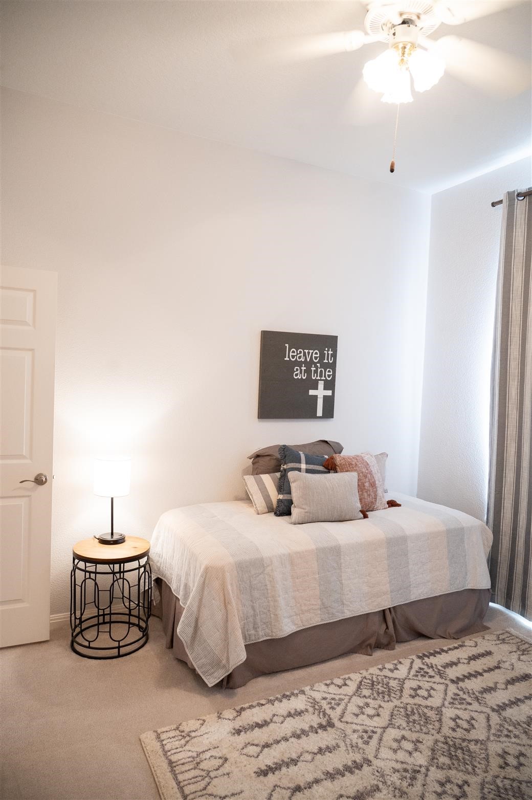 77 Panorama Drive Conroe, TX 77304 - Photo 34 of 49 a bedroom with a bed and a chandelier