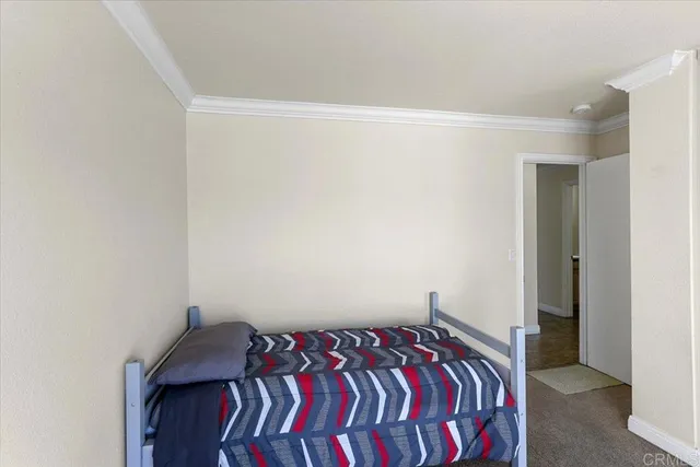 a bed sitting in a bedroom next to a window