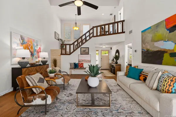 a living room with furniture or chandelier and a wooden floor
