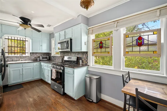 a kitchen with a stove a sink and a refrigerator