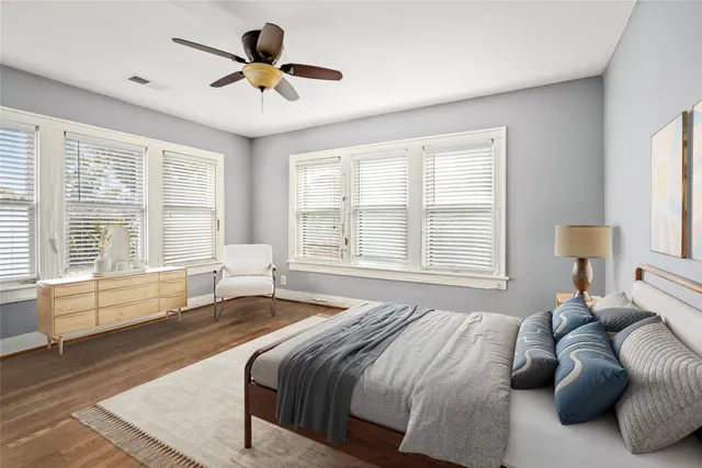 a spacious bedroom with a large bed and a large window