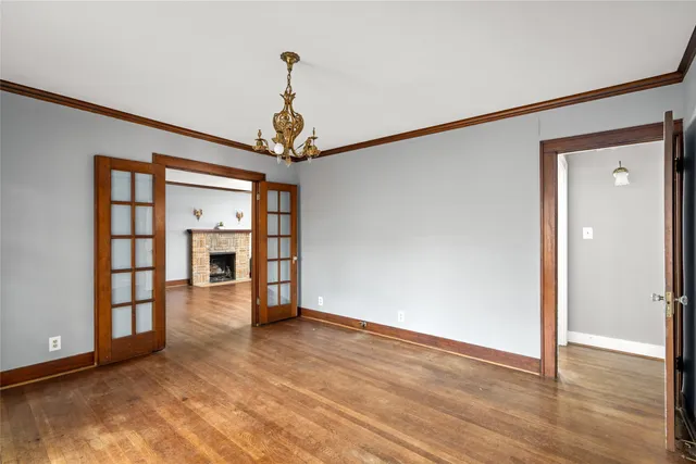 a view of a livingroom with wooden floor and a ceiling fan