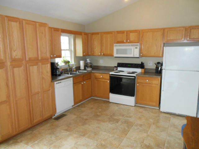 4751 West Westvale Road Northeast Roanoke, VA 24019 - Photo 2 of 25 a kitchen with a stove top oven sink and cabinets
