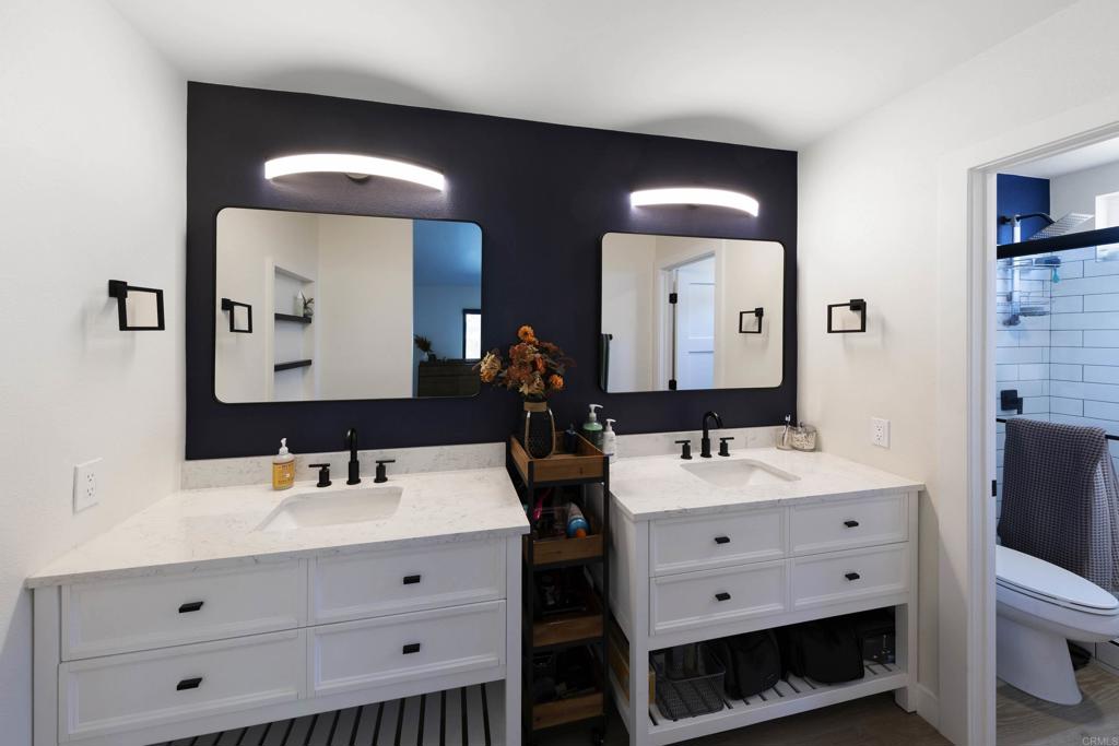 3577 Winslow Road Oceanside, CA 92056 - Photo 24 of 53 a bathroom with a double vanity sink and a mirror