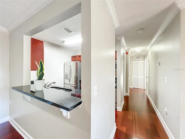 a hallway with mirror and shower