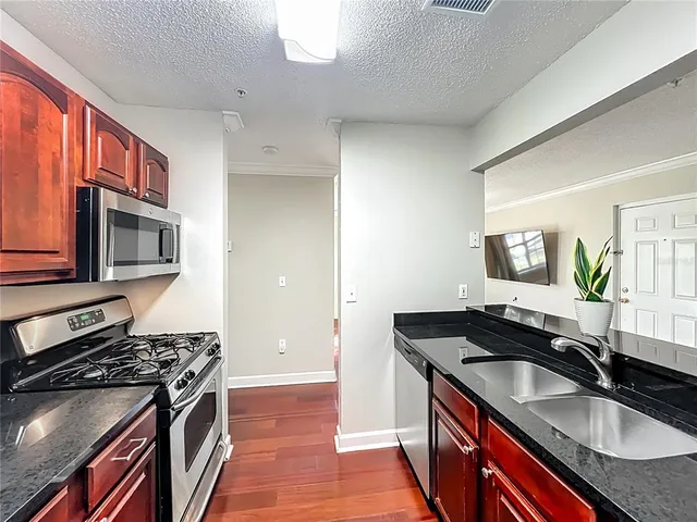 a kitchen that has a sink and a stove