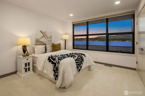 a bedroom with a large bed and a balcony view