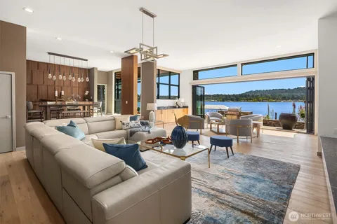 a living room with furniture and a chandelier