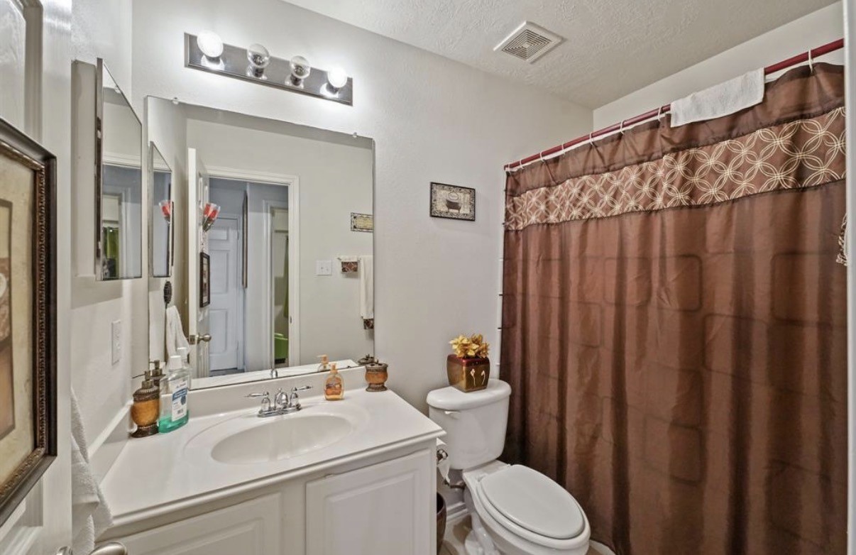 13134 Peppergate Lane Houston, TX 77044 - Photo 20 of 23 a bathroom with a sink toilet and shower