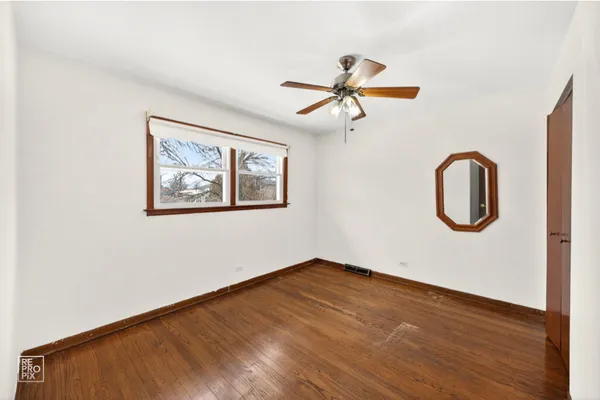 a view of a room with wooden floor and white wall
