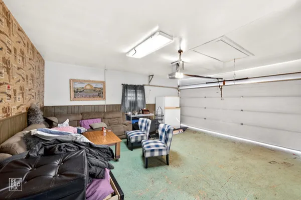 a bedroom with furniture and a chandelier