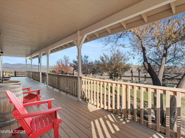 a balcony with wooden floor and outdoor seating