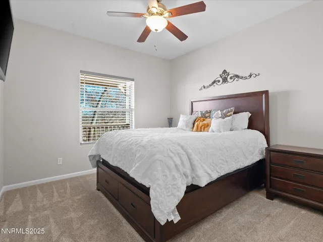 a bedroom with furniture and a book shelf