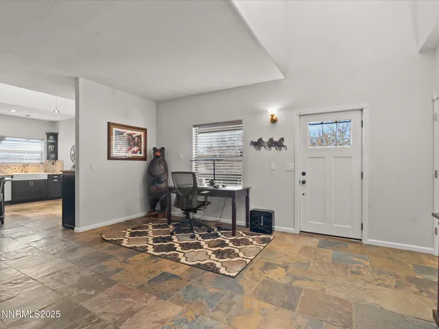 a view of a livingroom with wooden floor and furniture