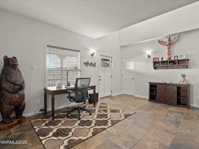 a living room with furniture a fireplace and a chandelier