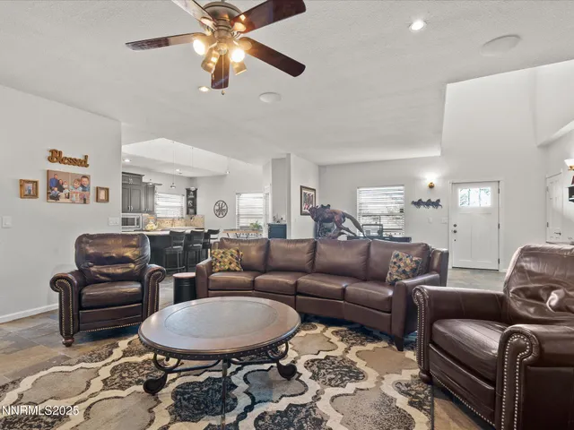 a kitchen with kitchen island granite countertop a sink counter and chairs