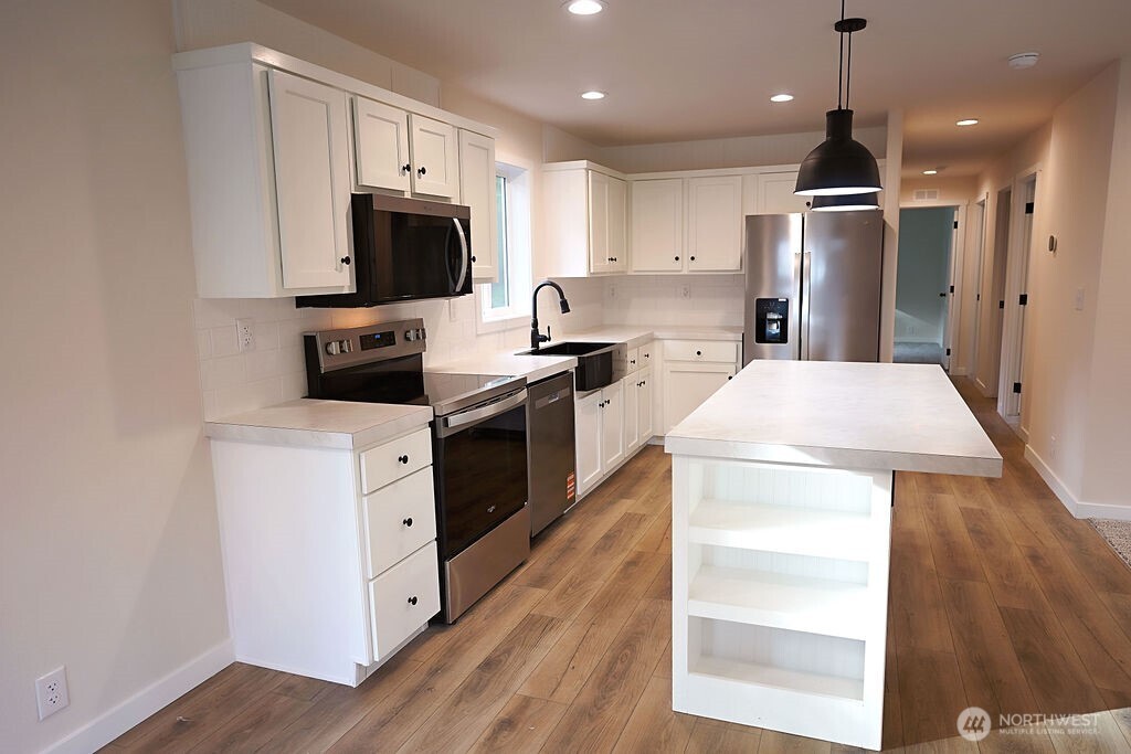 50 East Lookout Court Grapeview, WA 98546 - Photo 12 of 34 a kitchen with stainless steel appliances a stove microwave and refrigerator