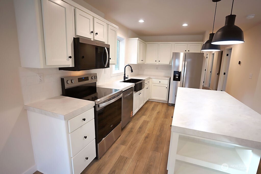 50 East Lookout Court Grapeview, WA 98546 - Photo 14 of 34 a kitchen with stainless steel appliances a stove microwave and a refrigerator