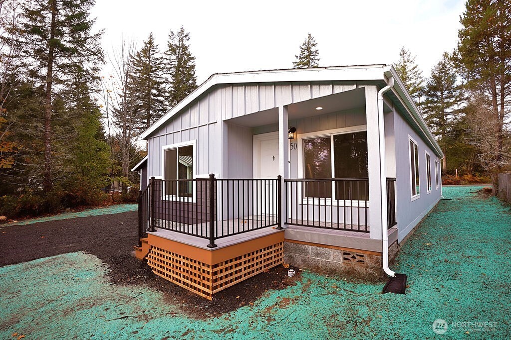 50 East Lookout Court Grapeview, WA 98546 - Photo 28 of 34 a view of a house with a yard and deck