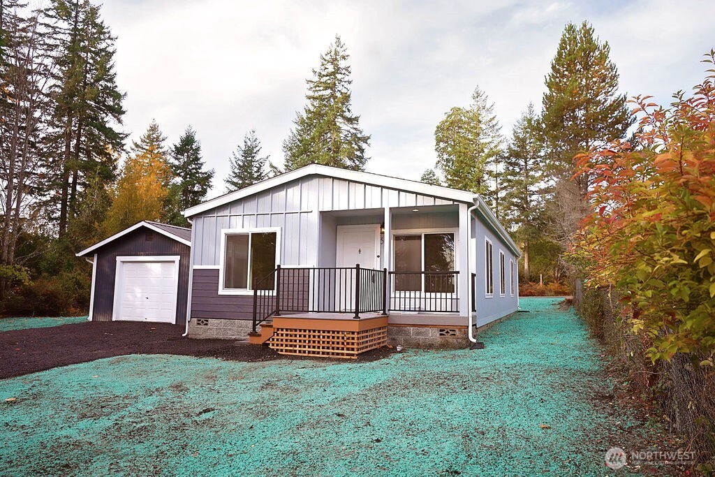 50 East Lookout Court Grapeview, WA 98546 - Photo 3 of 34 a front view of a house with garden
