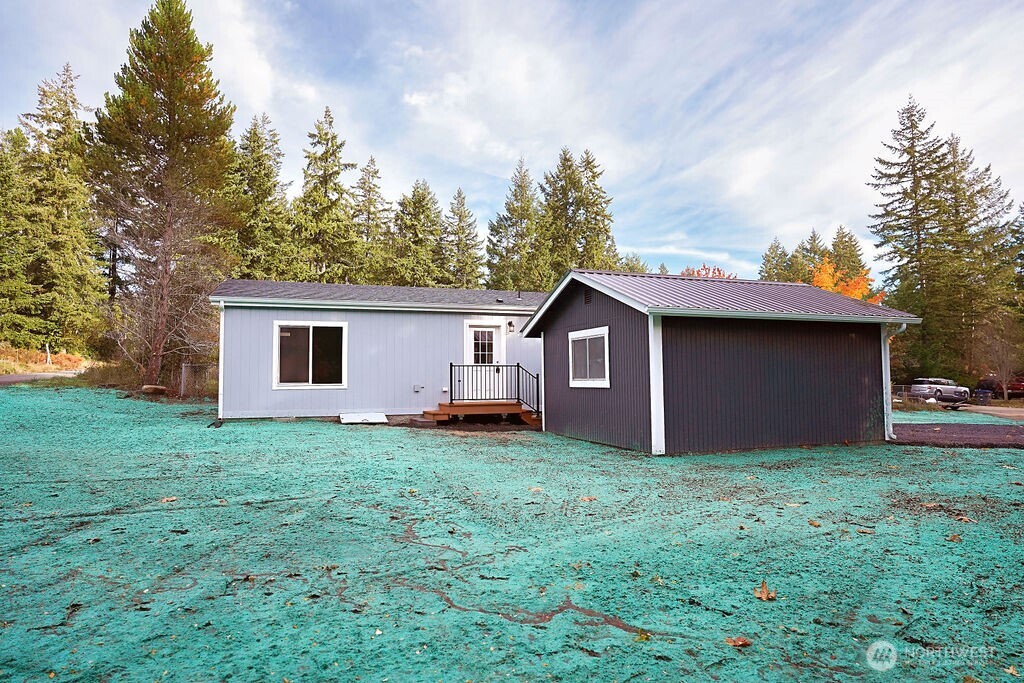 50 East Lookout Court Grapeview, WA 98546 - Photo 33 of 34 a view of a house with a yard