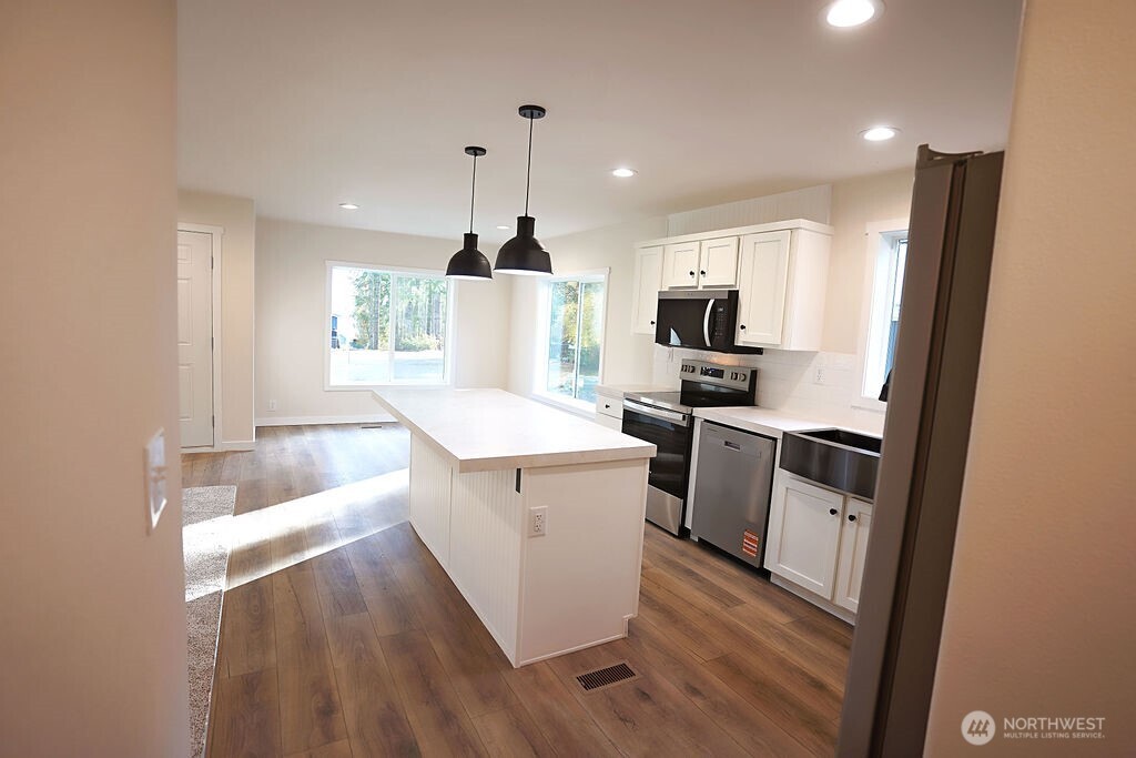 50 East Lookout Court Grapeview, WA 98546 - Photo 6 of 34 a kitchen with a sink a microwave a stove and refrigerator