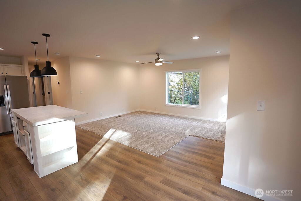 50 East Lookout Court Grapeview, WA 98546 - Photo 8 of 34 a view of a kitchen with furniture and wooden floor