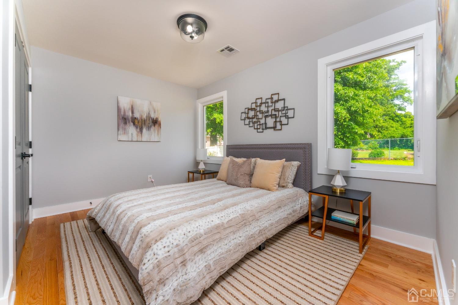 45 East Cliff Road Colonia, NJ 07067 - Photo 12 of 31 a bedroom with a bed and a painting on the wall