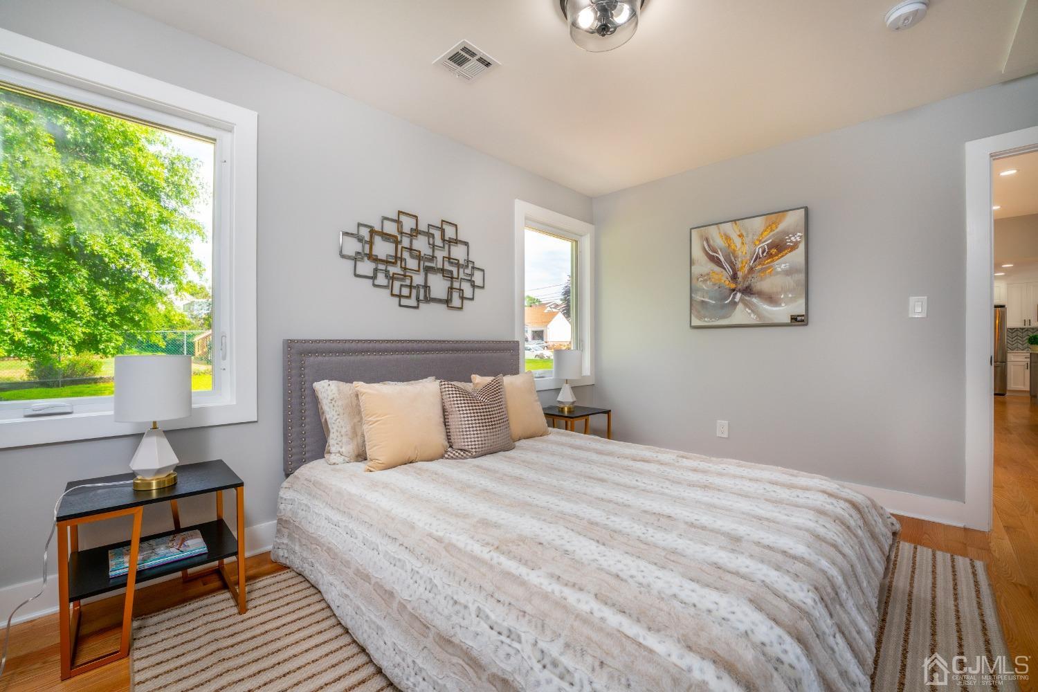 45 East Cliff Road Colonia, NJ 07067 - Photo 13 of 31 a bedroom with a bed and wooden floor