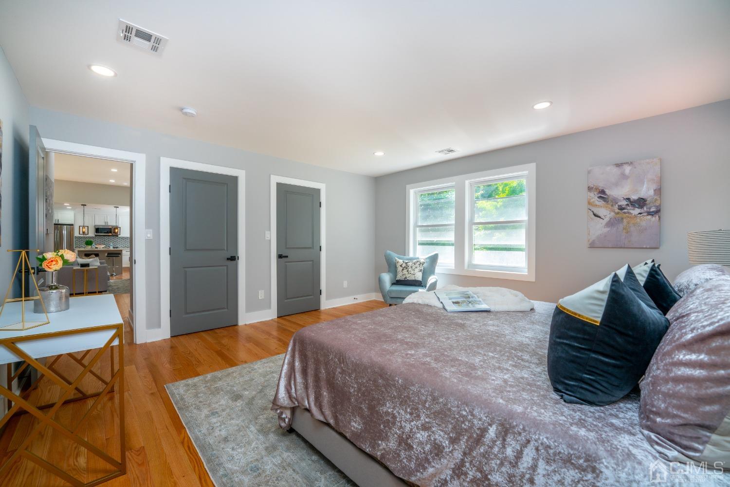 45 East Cliff Road Colonia, NJ 07067 - Photo 17 of 31 a bedroom with a large bed a couch and a window