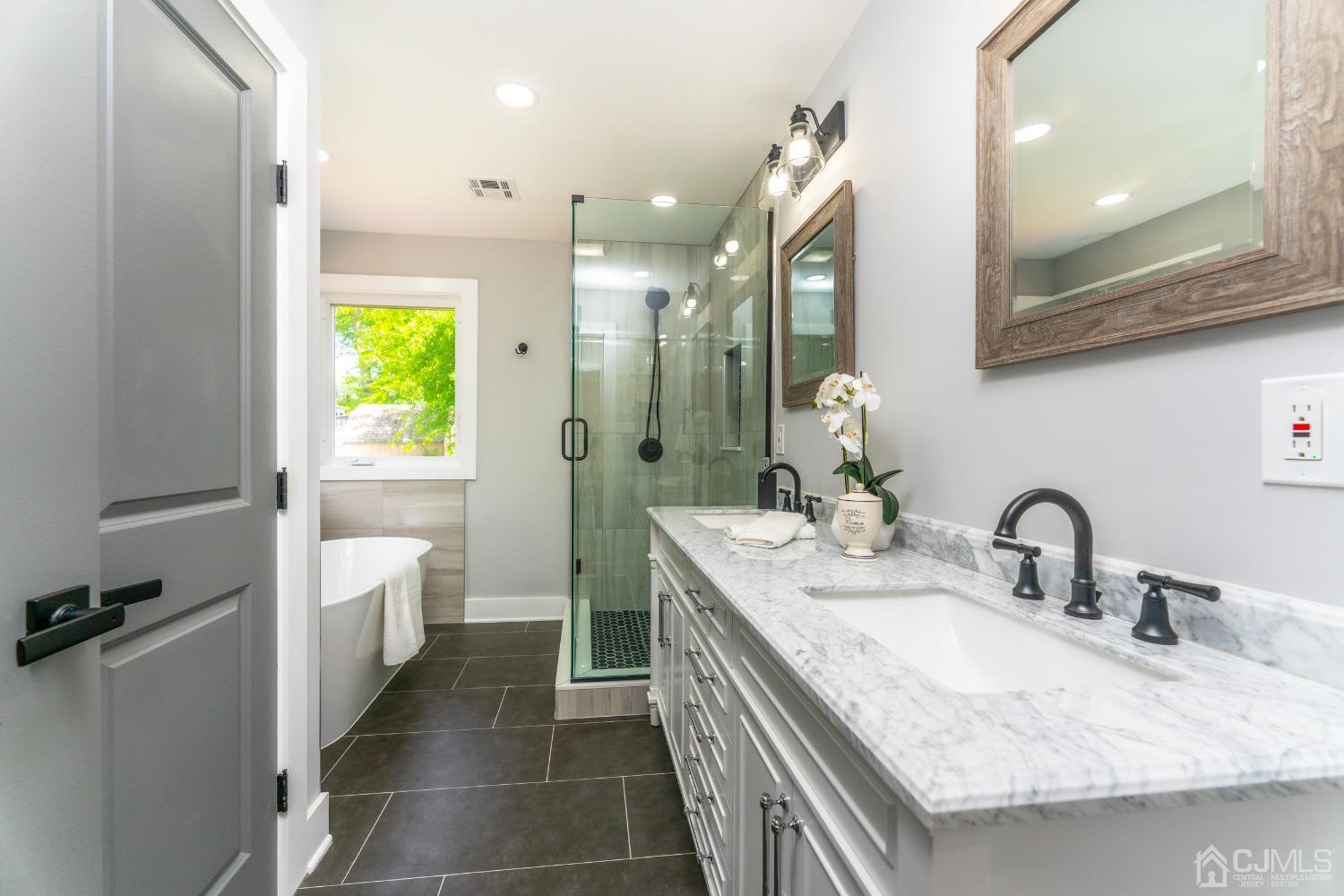 45 East Cliff Road Colonia, NJ 07067 - Photo 18 of 31 a bathroom with a double vanity sink and a mirror