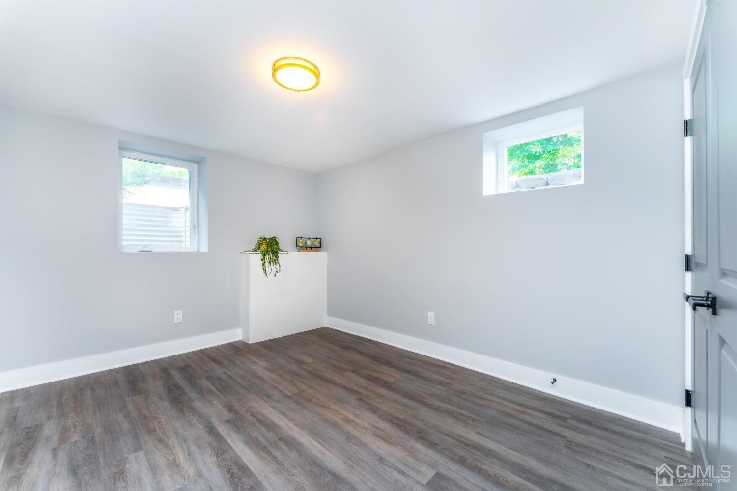 45 East Cliff Road Colonia, NJ 07067 - Photo 20 of 31 a view of an empty room with window and wooden floor