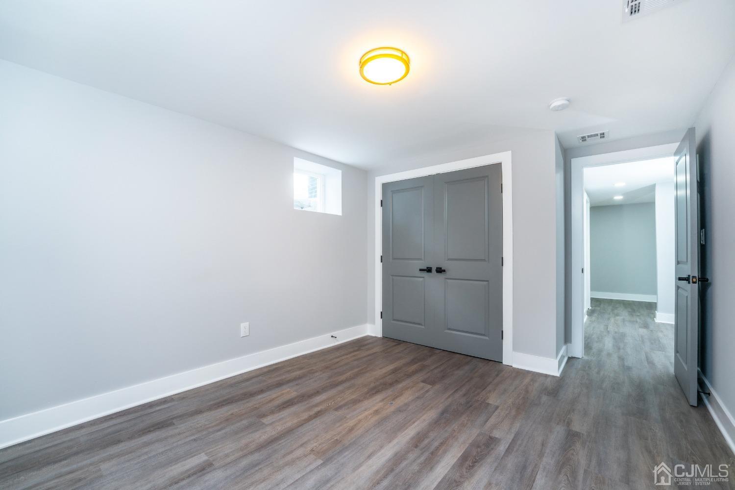 45 East Cliff Road Colonia, NJ 07067 - Photo 21 of 31 a view of a room with wooden floor and window