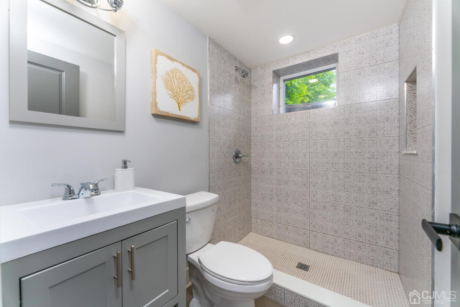 45 East Cliff Road Colonia, NJ 07067 - Photo 22 of 31 a bathroom with a sink a toilet and shower