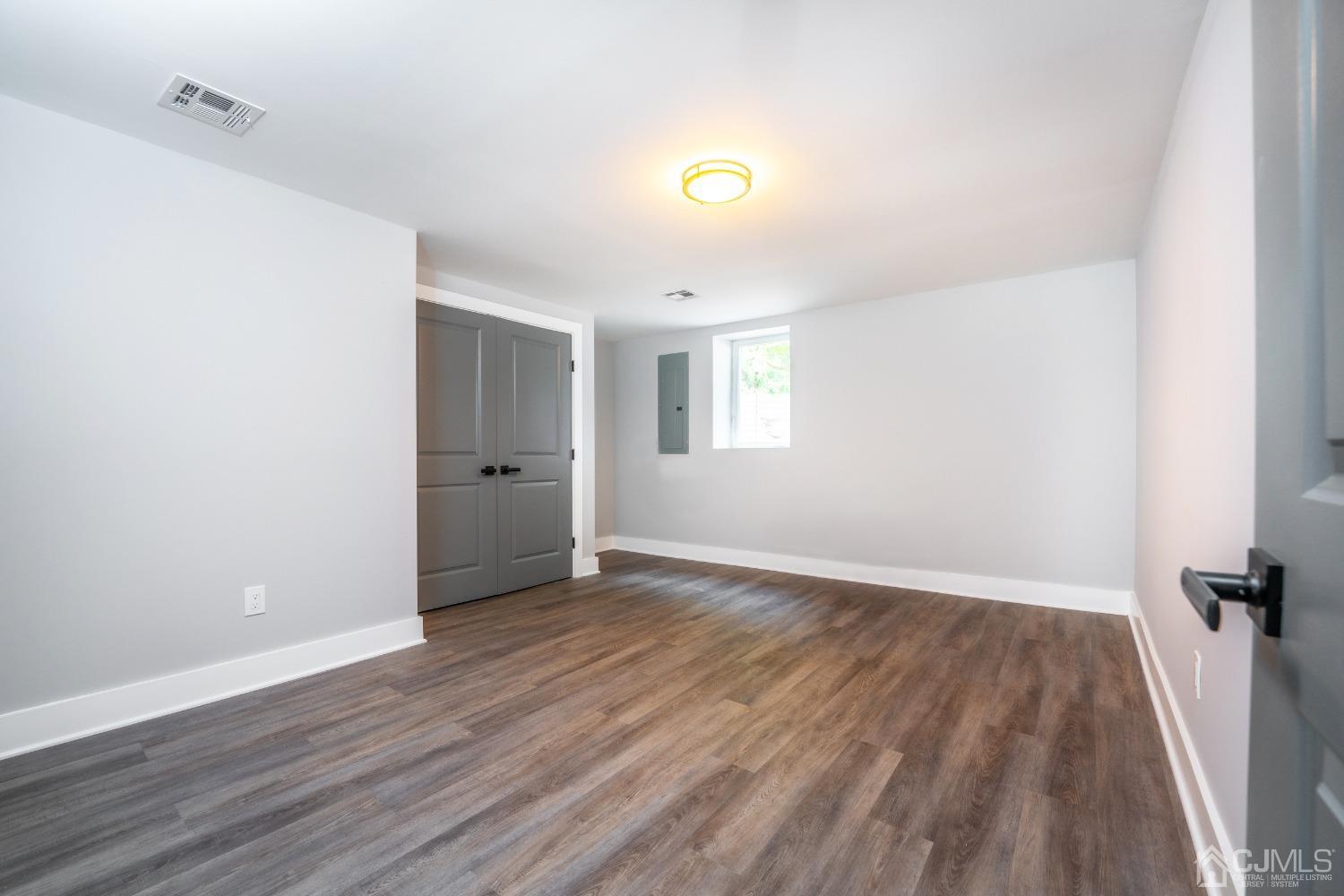 45 East Cliff Road Colonia, NJ 07067 - Photo 24 of 31 wooden floor in an empty room with a window