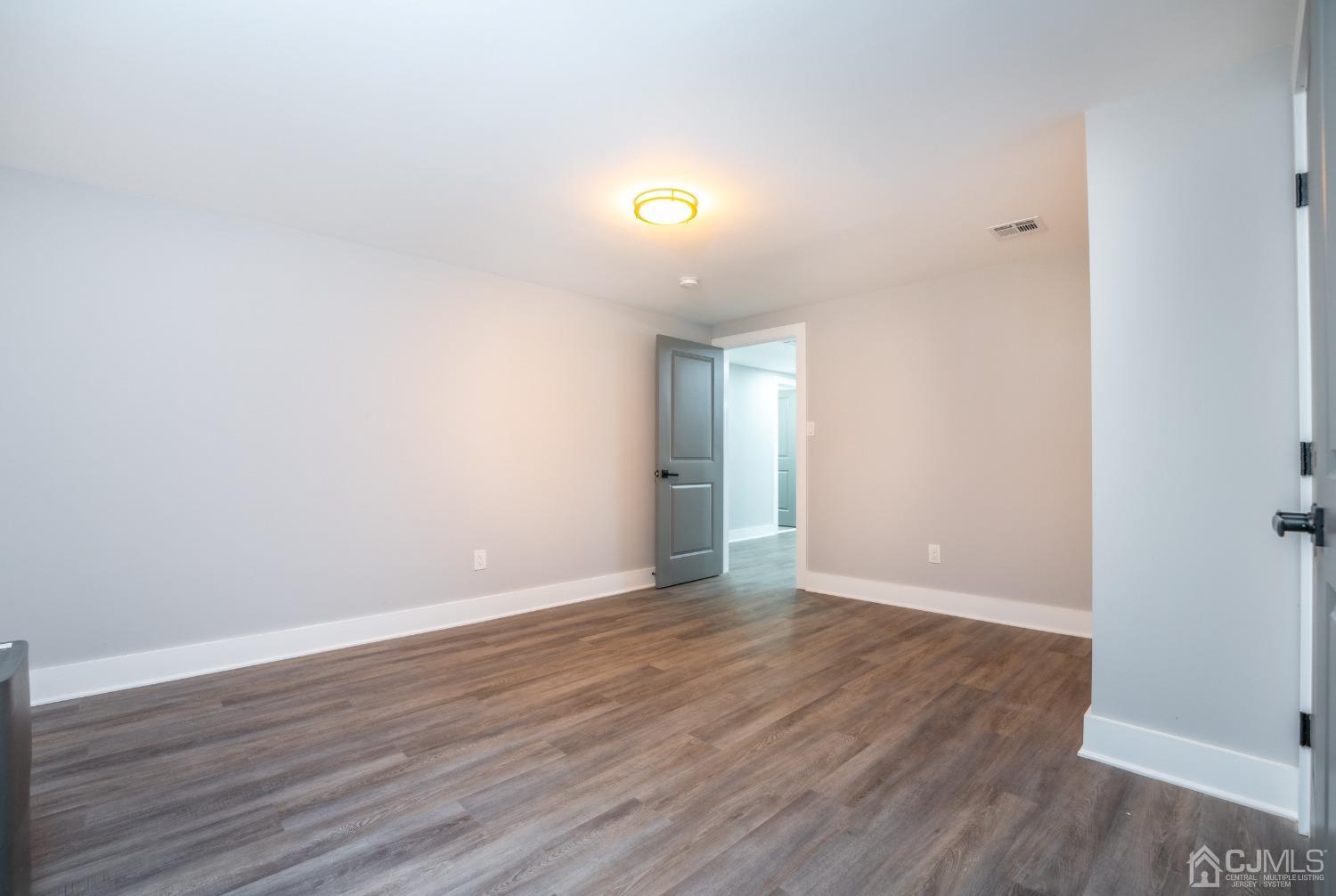 45 East Cliff Road Colonia, NJ 07067 - Photo 25 of 31 a view of an empty room with wooden floor