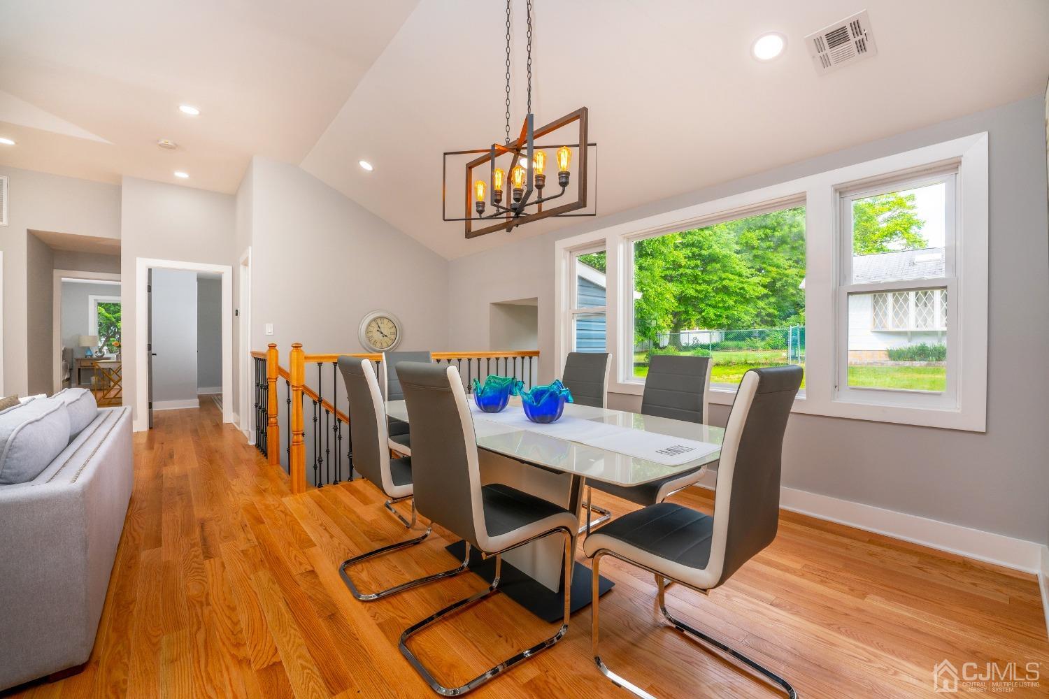 45 East Cliff Road Colonia, NJ 07067 - Photo 6 of 31 a view of a dining room with furniture a chandelier and wooden floor