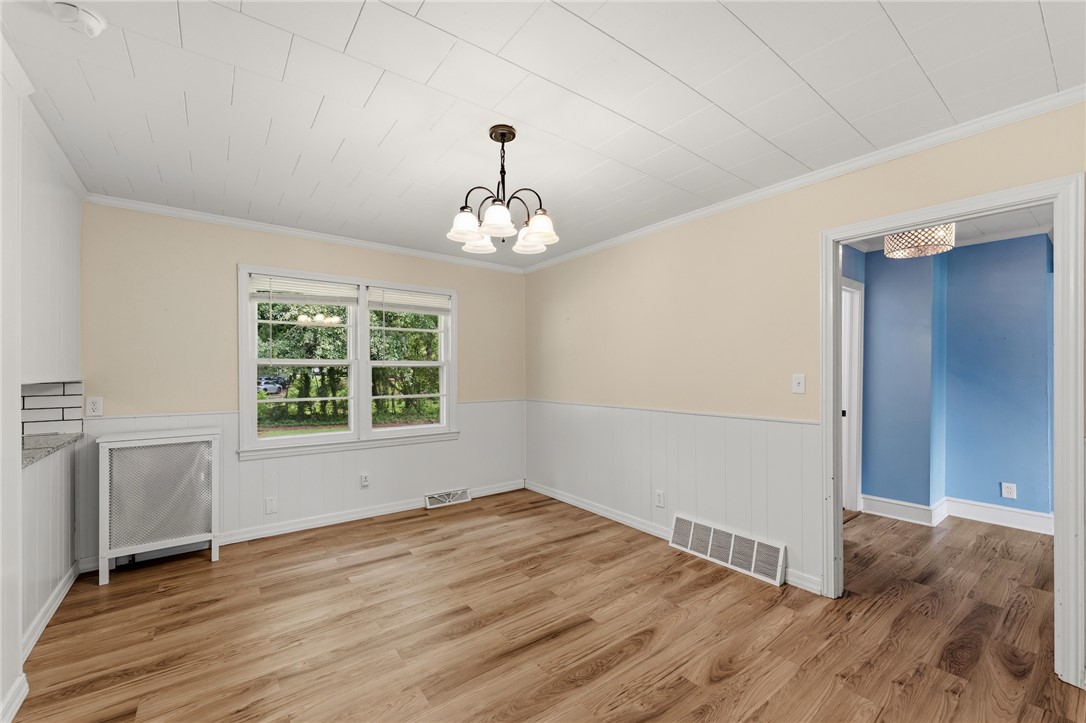 12 Dendy Street Pelzer, SC 29669 - Photo 6 of 31 A warm and inviting dining area with hardwood flooring, ready for memorable gatherings.