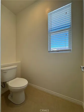 a white toilet sitting next to a white sink