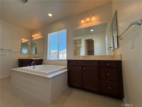 a bathroom with a sink vanity and a mirror