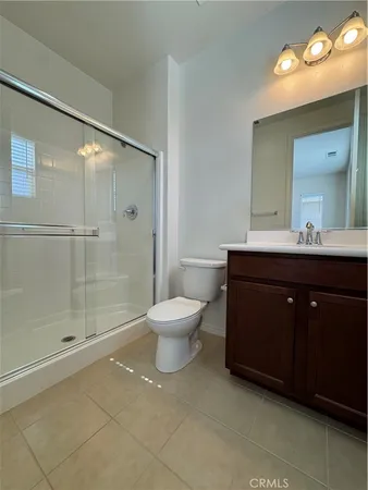 a bathroom with a sink toilet a mirror and shower