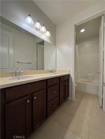 a bathroom with a sink double vanity and a mirror