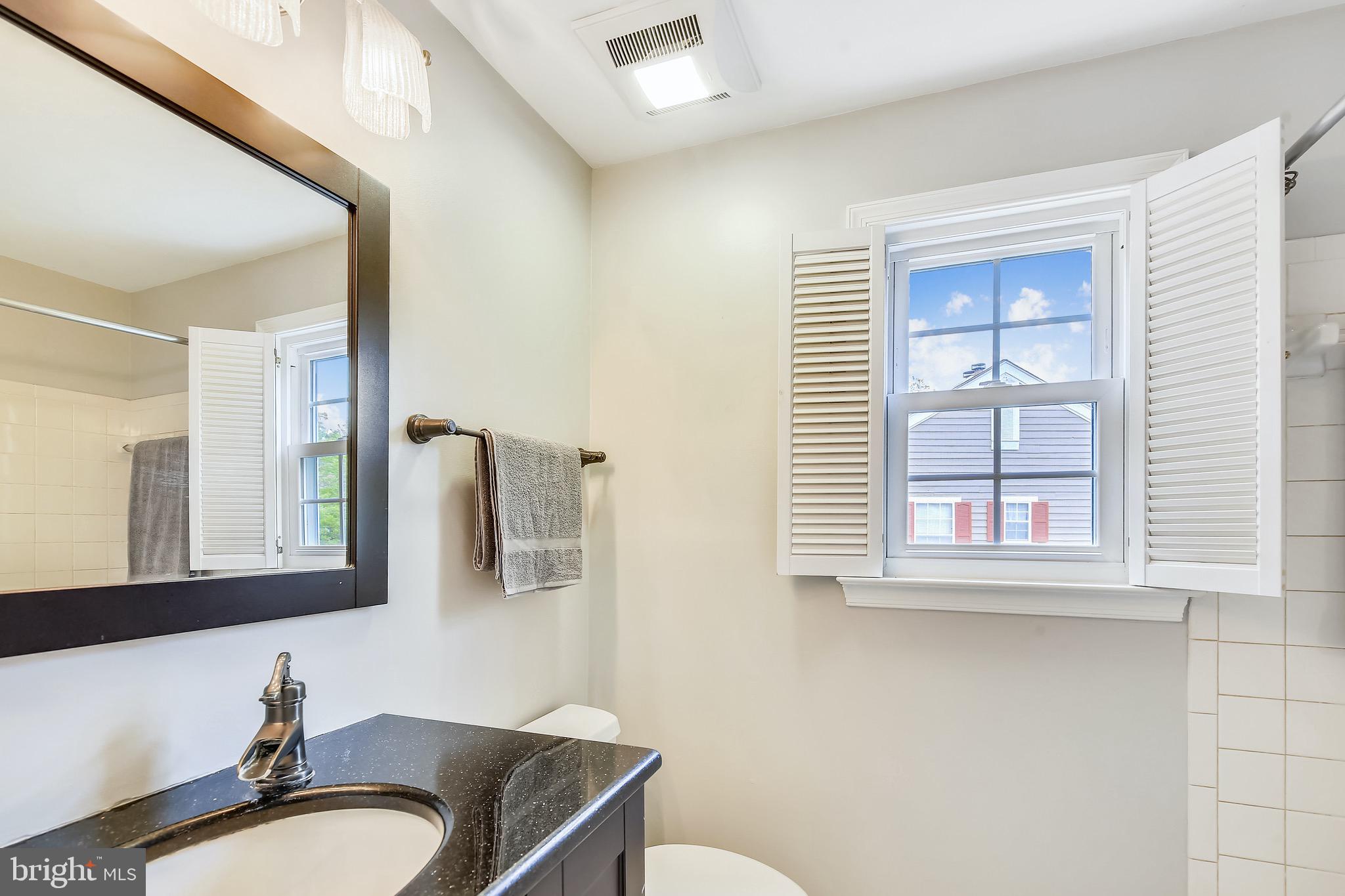 1530 Deer Point Way Reston, VA 20194 - Photo 20 of 42 a bathroom with a granite countertop toilet sink and mirror