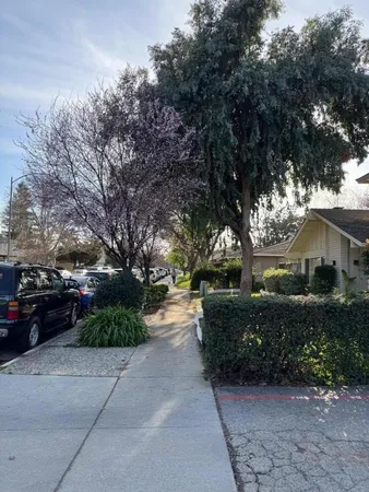 a front view of a house with a garden