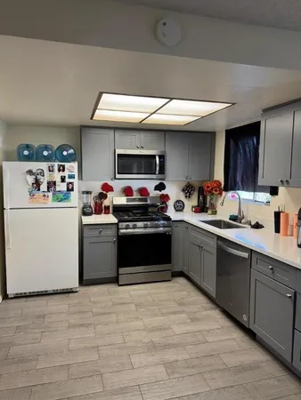 a kitchen with stainless steel appliances kitchen island granite countertop a sink counter top space and cabinets