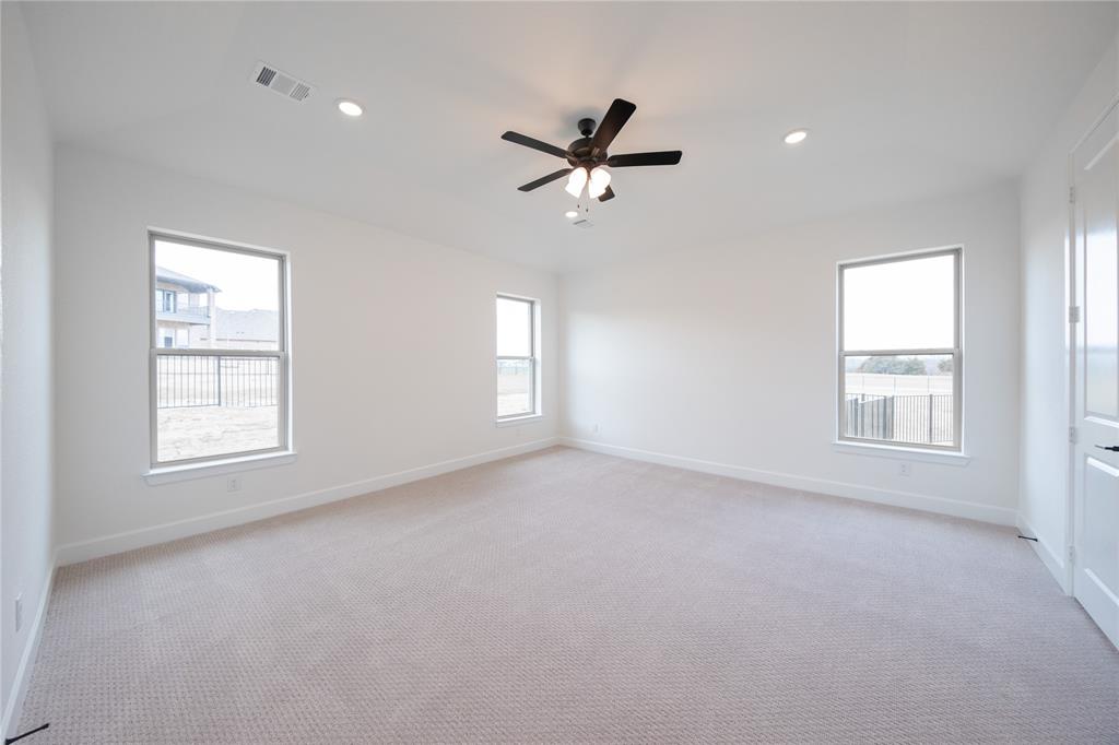 2715 Triumph Court Heath, TX 75126 - Photo 8 of 30 an empty room with windows and closet fan