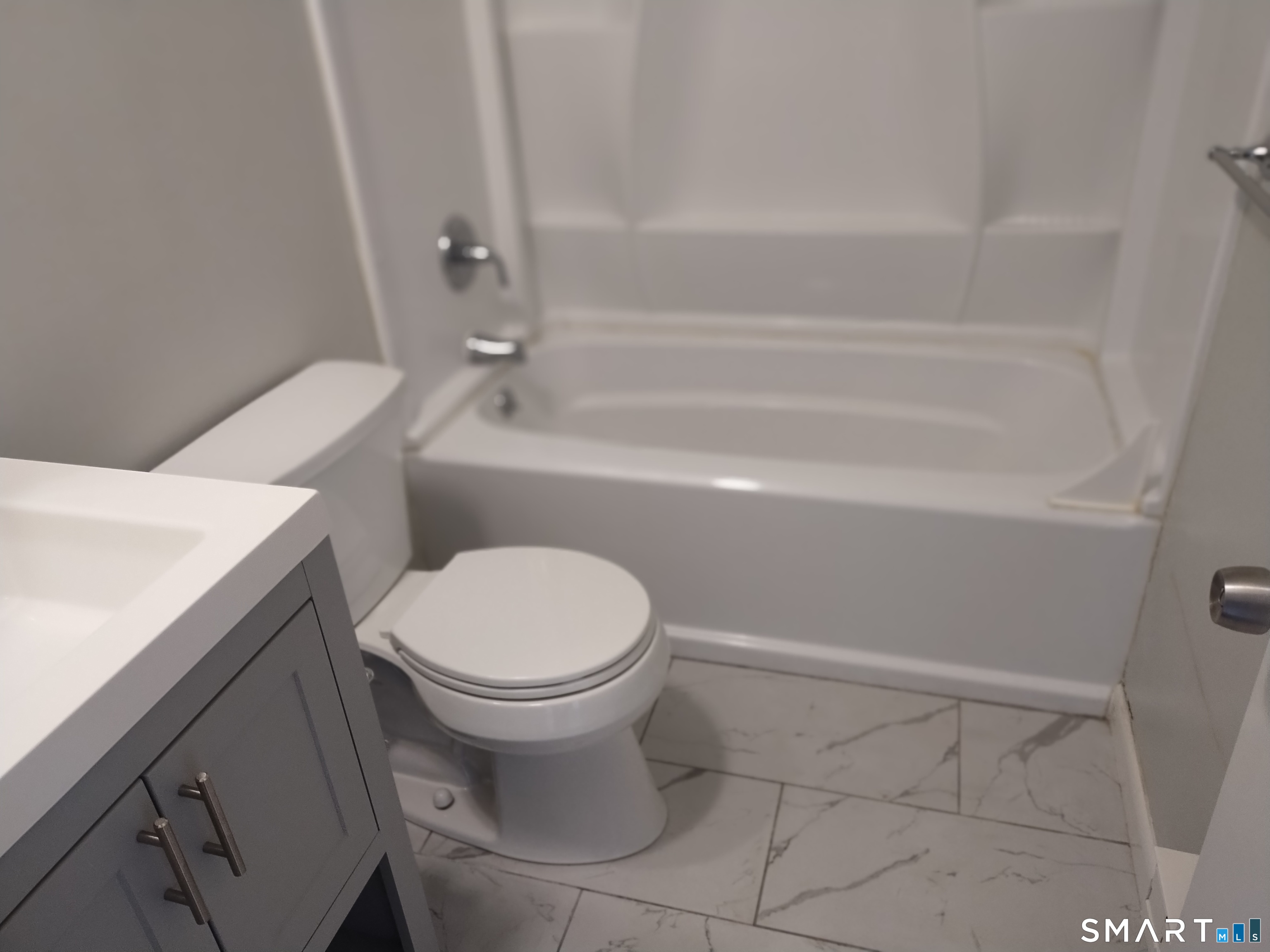 115 Short Beach Road, Unit 307 Stratford, CT 06615 - Photo 16 of 32 a bathroom with a toilet and a bathtub