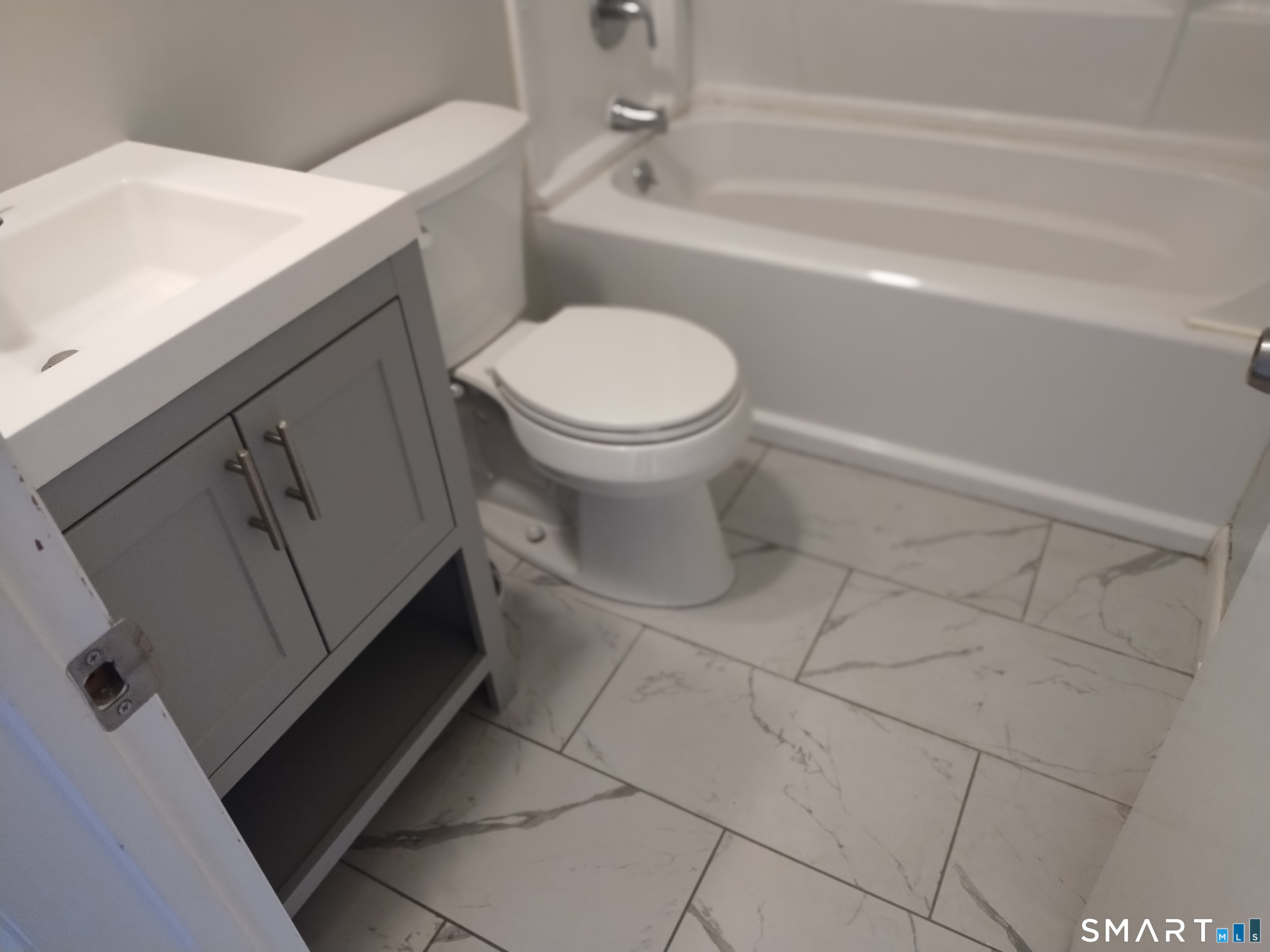 115 Short Beach Road, Unit 307 Stratford, CT 06615 - Photo 17 of 32 a bathroom with a toilet and a sink