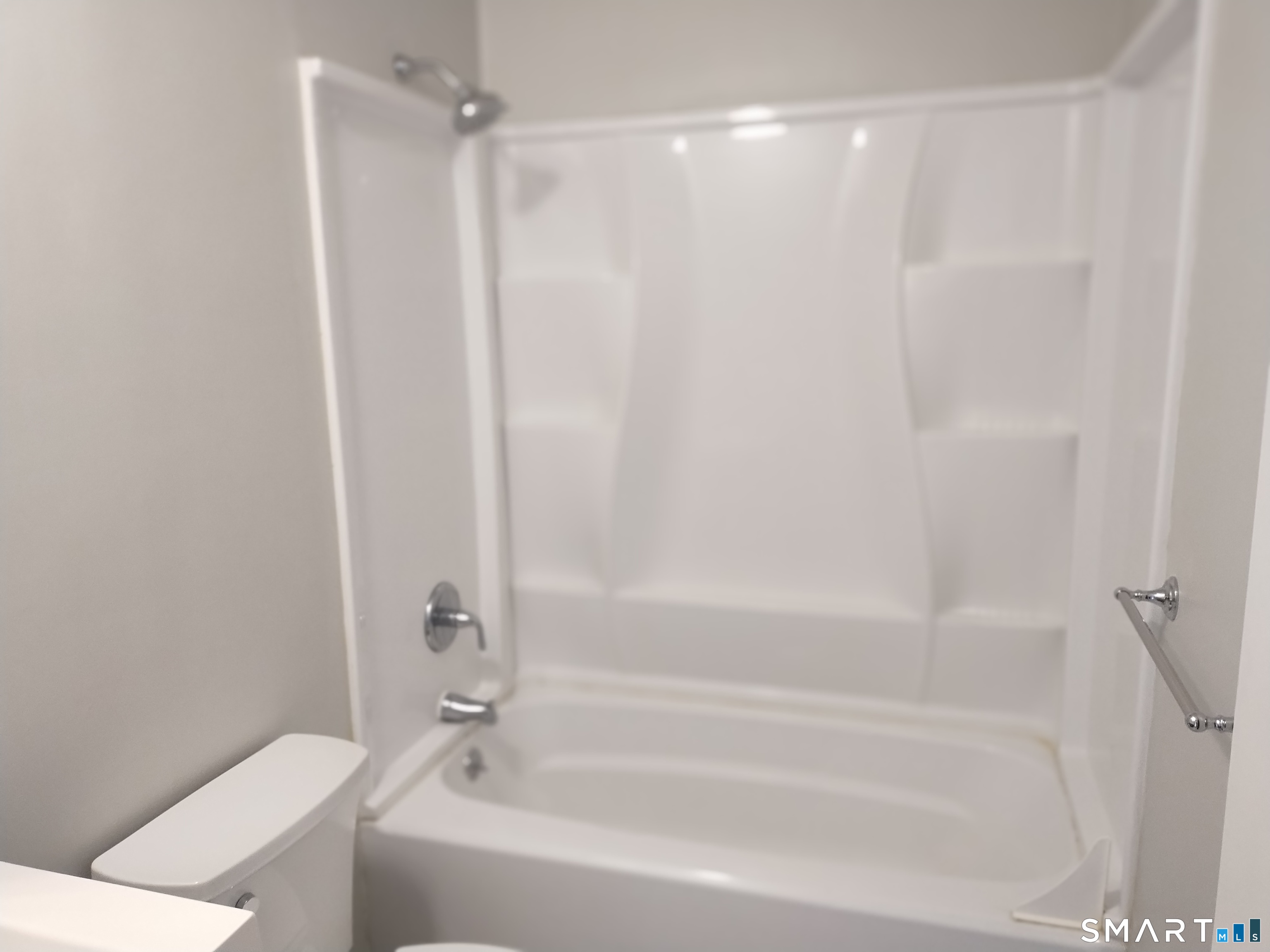 115 Short Beach Road, Unit 307 Stratford, CT 06615 - Photo 18 of 32 a bathroom with a bathtub and a shower